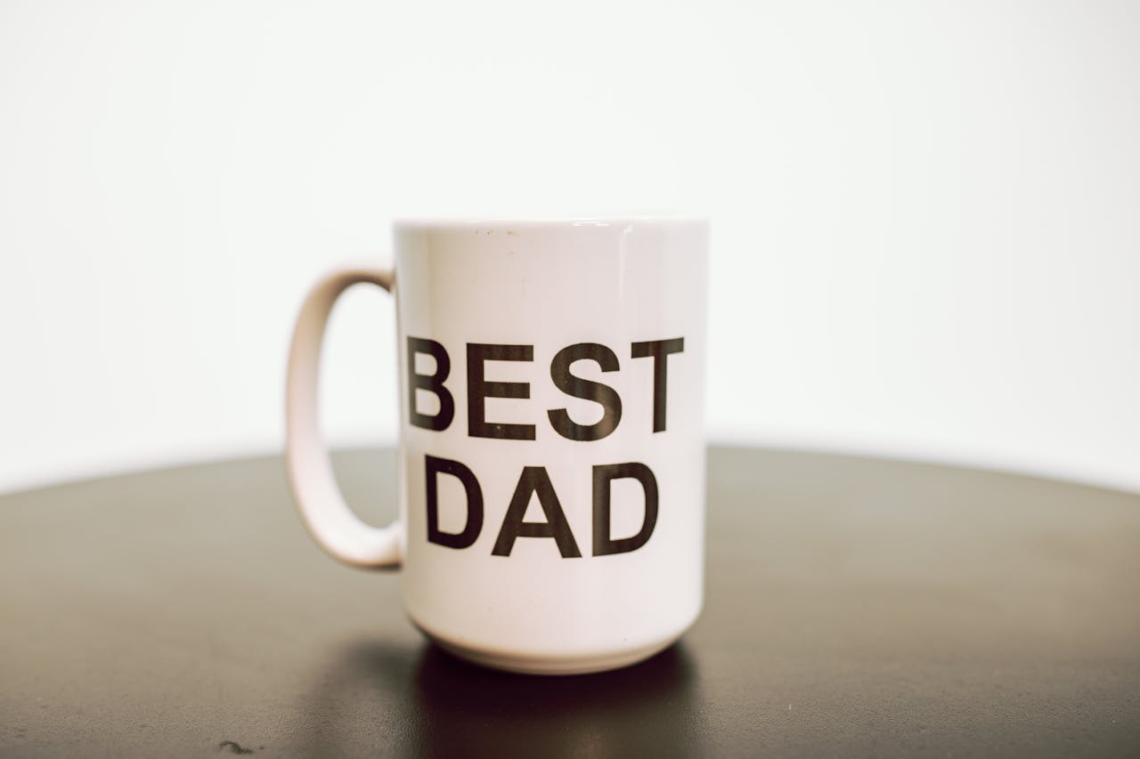 Simple white mug with 'BEST DAD' text, perfect for Father's Day gifts.